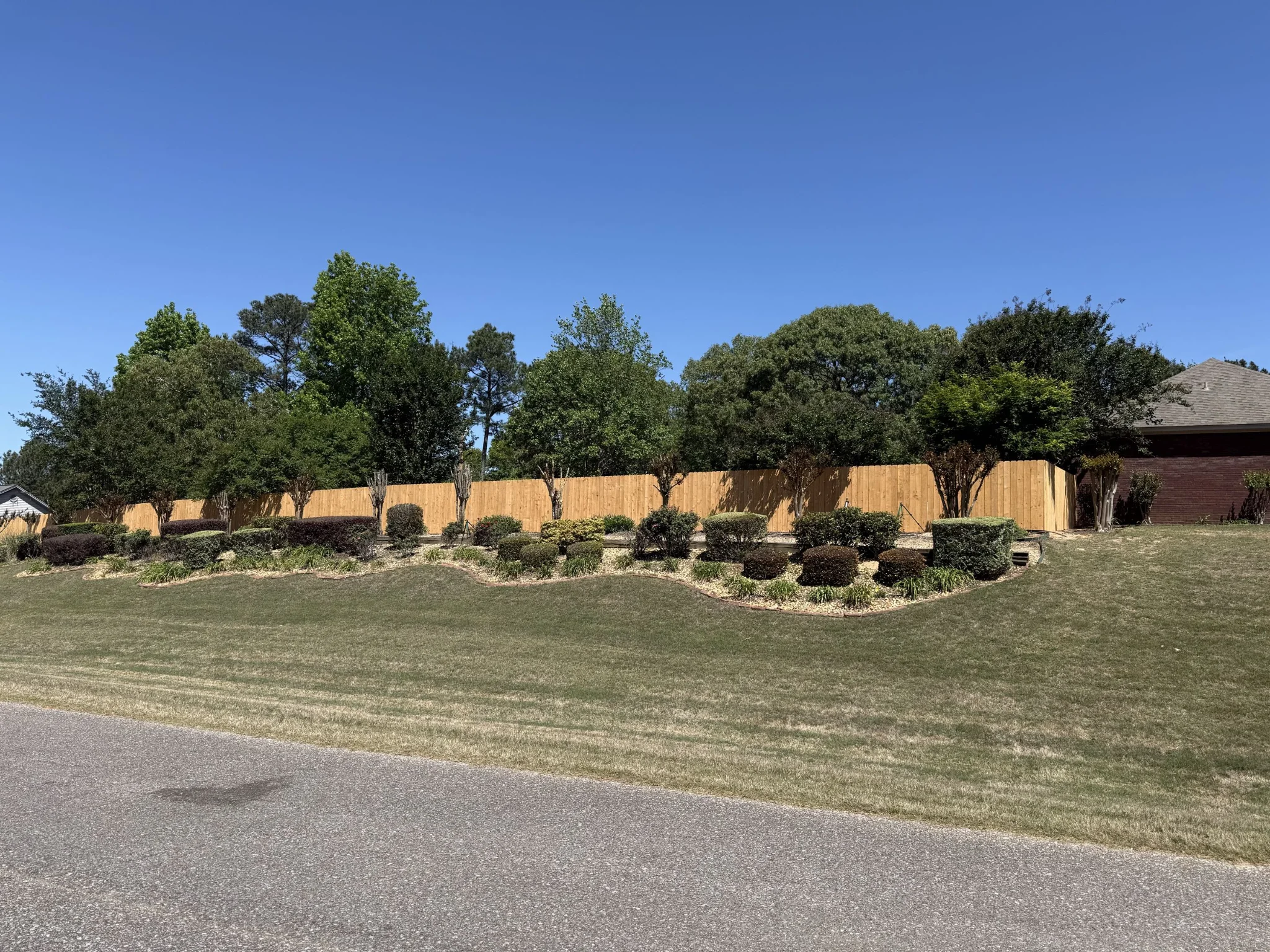 Wood privacy fence with landscaping by Ray's Fencing and Outdoor — Alabama